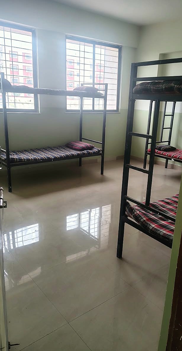 Naturally lit hostel room with two bunk beds
